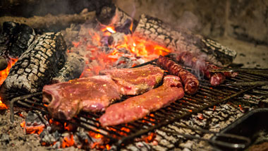 Meat on the fire of the old fireplace